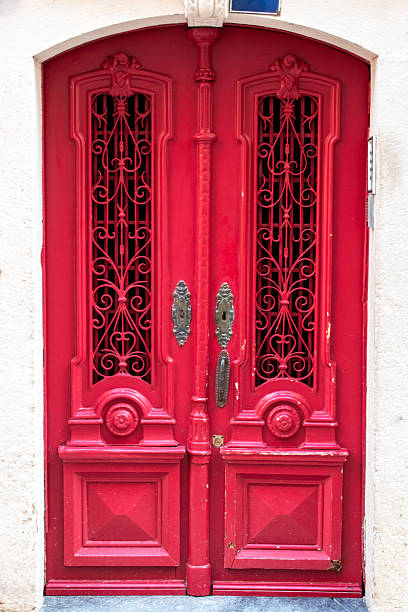 istock Vibrant Red Ornate Double Door with Wrought Iron Details 2253315866