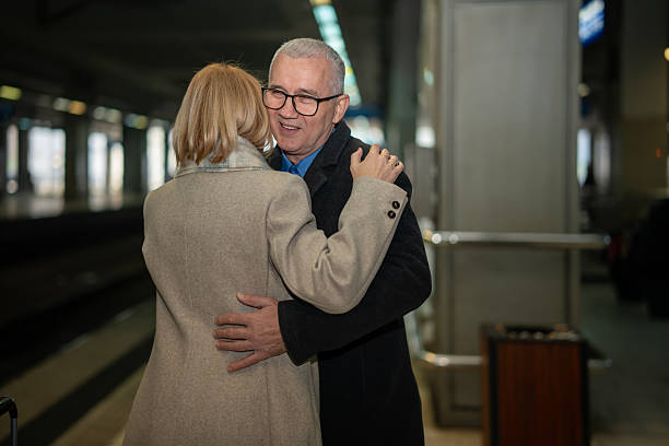 istock Senior couple hugging at train station reunion 2253317206