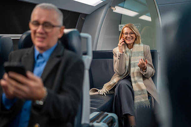 istock Senior woman talking on phone while commuting by train 2253317271