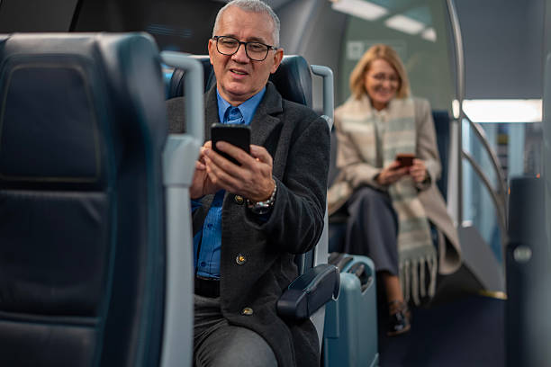 istock Mature man using smartphone traveling on train 2253317320