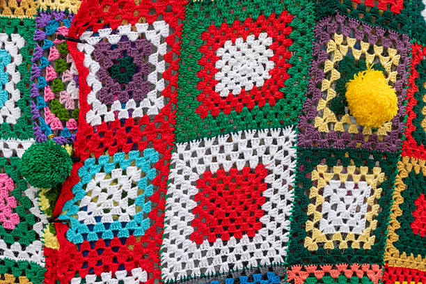 Handmade crochet blanket showing an array of colorful granny squares with delicate textures