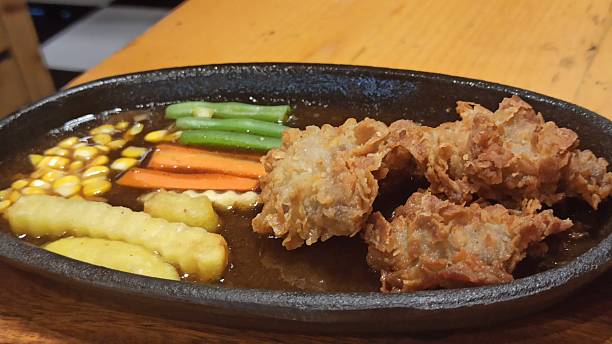 istock Fried Chicken and Potatoes on a Hot Plate 2253319005