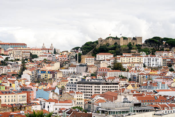Lisbon Portugal December 06 2025. Dense residential buildings spread across hills below Sao Jorge Castle overlooking the city.