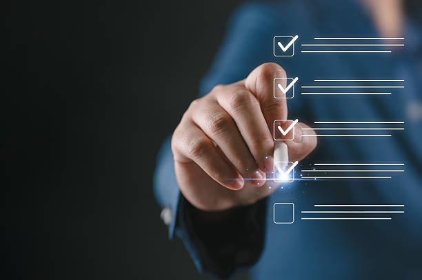 istock Performance checklist and tracking business performance, businessperson using pen to mark checkboxes, conducting audits Evaluation questionnaire Survey via online digital form. 2253319341