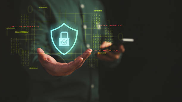 istock Businessman holding smartphone with digital shield and padlock hologram, representing cybersecurity, data protection, encryption, online privacy, secure technology and information security. 2253319600
