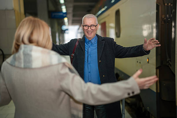 istock Mature couple having touching reunion at train station platform 2253320042