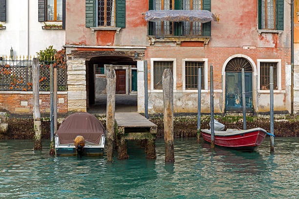 Old Buildings Wooden Columns Moored Boats at Grand Canal in Venice Italy Winter Season