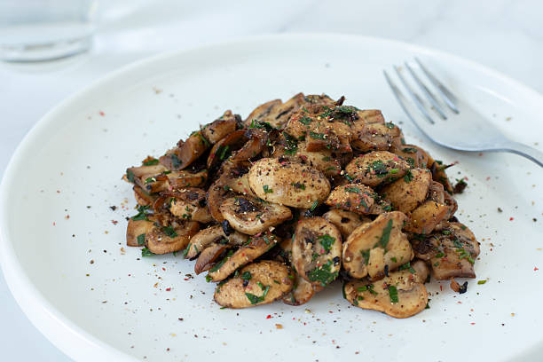 istock Spicy mushrooms in a plate on white kitchen table 2253322292