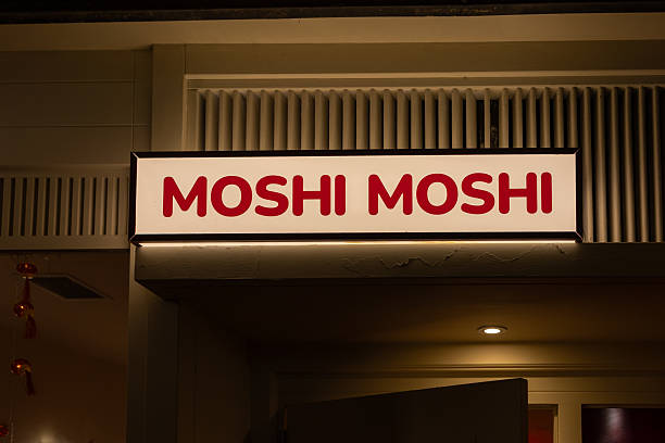 La coruña, spain; 12 14 2025 illuminated moshi moshi sign displaying a japanese restaurant entrance at night