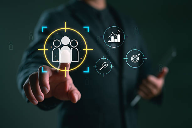 istock Businessman focuses on a target audience with strategy and data analysis icons, signifying customer focus for business and marketing strategies. 2253332802