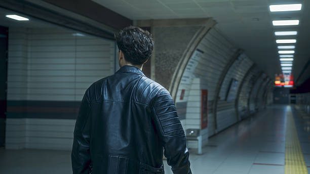 Man Walking in Modern Subway Station at Night