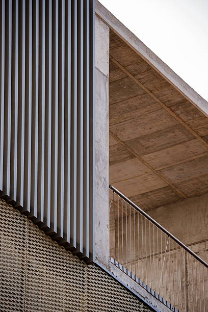 istock Geometric Contrast: Slats, Concrete, and Mesh Facade 2253335069