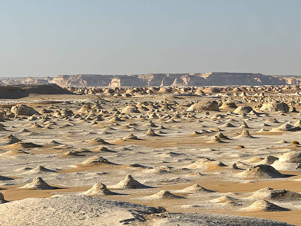 istock White Desert, Egypt - Chalk rock formations with distant plateau in Sahara Desert 2253335664