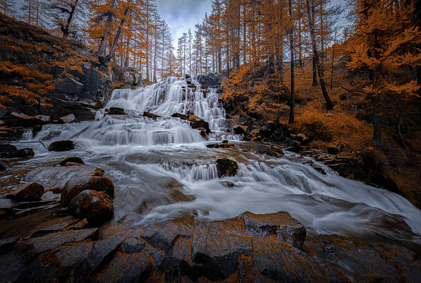 istock Waterfall and Golden Larches, Frace 2253338350