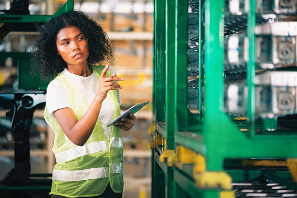istock African American female warehouse worker using digital tablet for inventory 2253340237