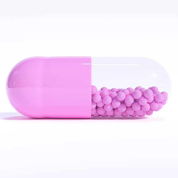 istock Purple Capsule Full of Granules On White Background 2253345336