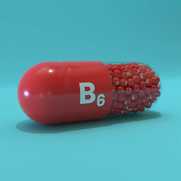 istock Vitamin B6 With Red Capsule, Granules and Turqoise Background 2253345619