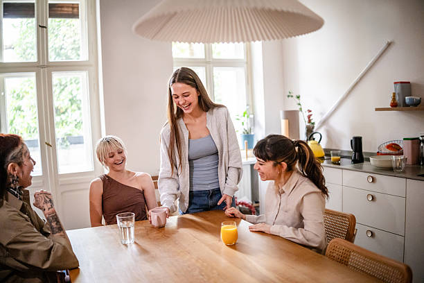 istock Young women enjoying drinks and laughter at home during the weekend in a cozy kitchen setting 2253346815