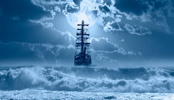 istock Sailing old ship in calm sea - Night sky with moon in the clouds 2253346928
