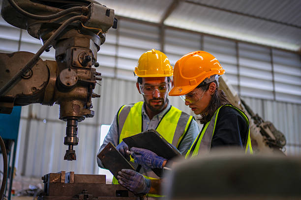 istock Blue collar workers are working at machine shop with CNC lathe  machine. 2253347798
