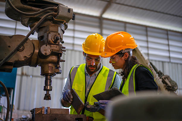 istock Blue collar workers are working at machine shop with CNC lathe  machine. 2253347800