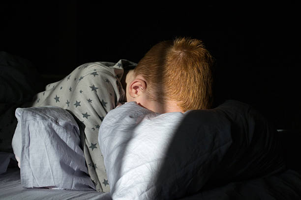 istock Child sleeps in bed at dawn 2253349129