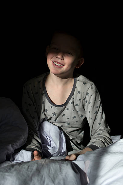 istock A boy with a phone is resting in bed. 2253349139