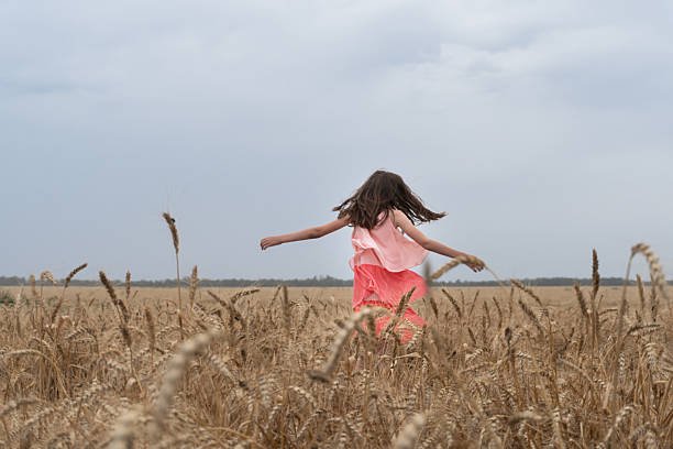 istock child in a field with yellow wheat 2253349705