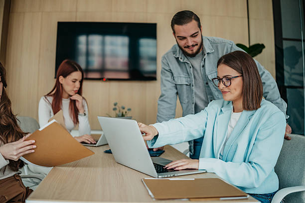 istock Group of coworkers collaborating on a project in a modern office space during work hours 2253349805