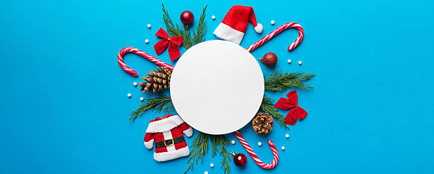 istock Flat lay Christmas composition. Round Paper blank, pine tree branches, christmas decorations on Colored background. Top view, copy space for text 2253351131