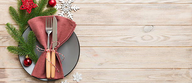 istock Christmas table place setting with christmas decor and plates, kine, fork and spoon. Christmas holiday background. Top view with copy space 2253351132