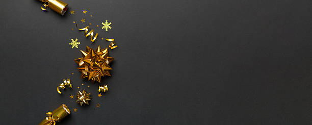 istock Christmas crackers with shiny confetti on color background, top view, copy space 2253351136