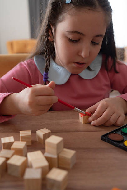 istock Girl painting cubes 2253351883
