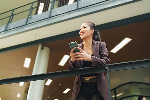 istock Professional woman using smartphone smiling with happiness 2253353721