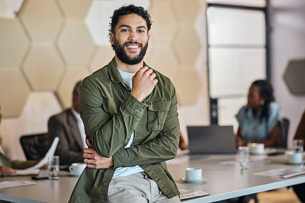 istock Confident Young Bearded Businessman Leaning on Table in Meeting 2253353833