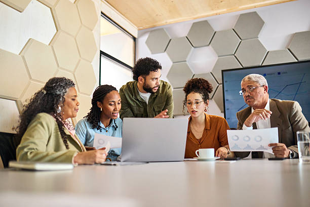 istock Diverse Business Team Huddling Over Laptop and Documents for Strategy 2253353855