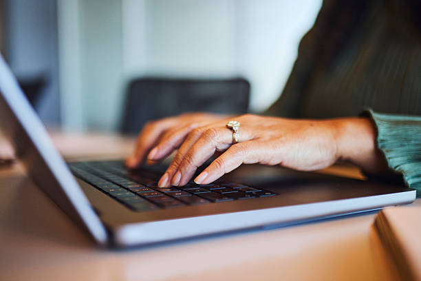 istock Close-up of Businesswoman's Hands Typing Efficiently on Laptop 2253353943