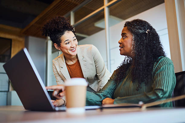 istock Diverse Businesswomen Collaborating on Laptop in Modern Office 2253353970