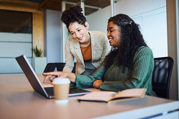 istock Diverse Businesswomen Collaborating on Laptop, Pointing at Screen 2253353983