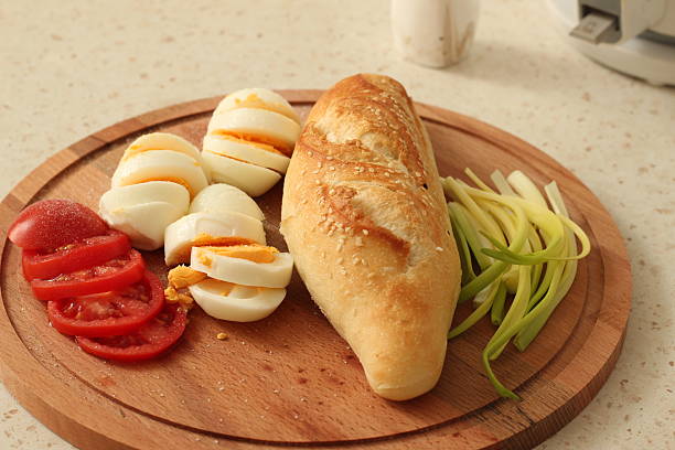 Simple Brunch with Boiled Eggs, Fresh Bread and Green Onions