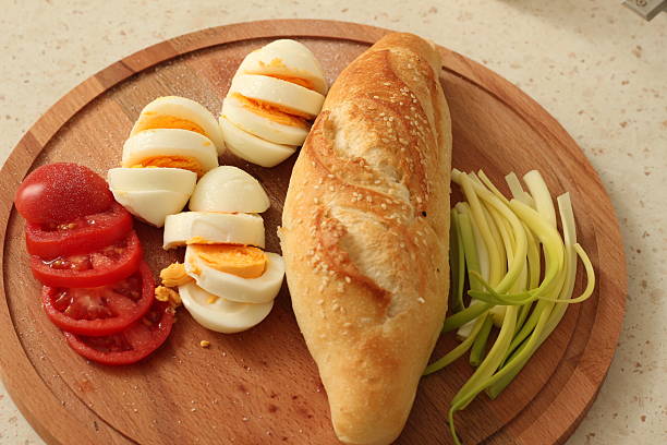 Simple Brunch with Boiled Eggs, Fresh Bread and Green Onions