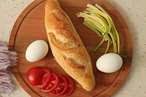 Simple Brunch with Boiled Eggs, Fresh Bread and Green Onions