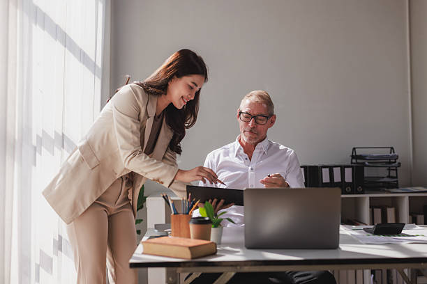 istock Diverse business partners collaborating examining financial report in office 2253355286