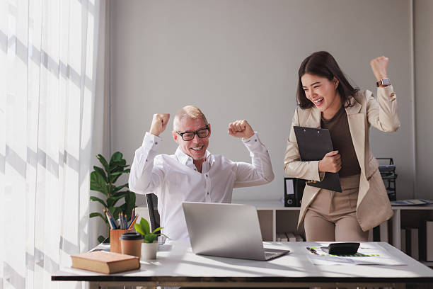 istock Business team celebrating success achieving goals working together 2253355347