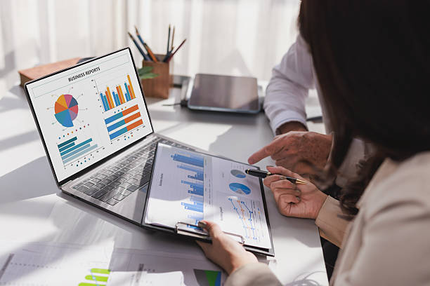 istock Business people analyzing financial reports and marketing data 2253355440