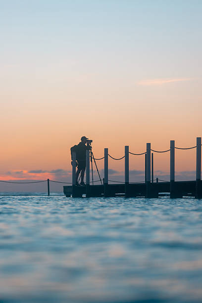 Photographer  having fun walking on salt lake at sunset