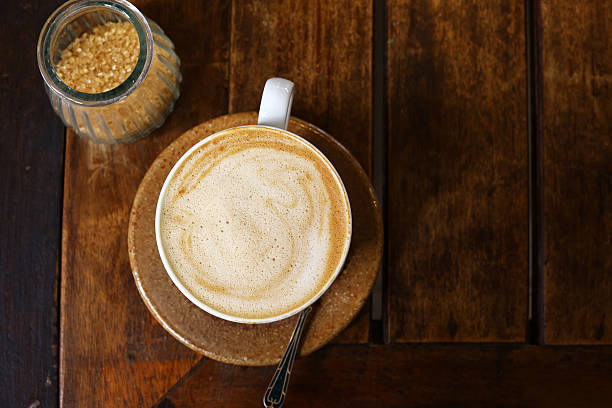 istock cup of cappuccino on wooden table for coffee break 2253356291
