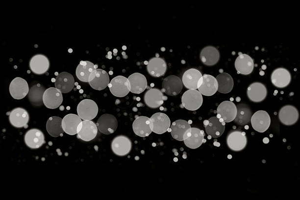 istock Abstract bokeh of glowing circles on a black background with soft lights and sparkles 2253357298