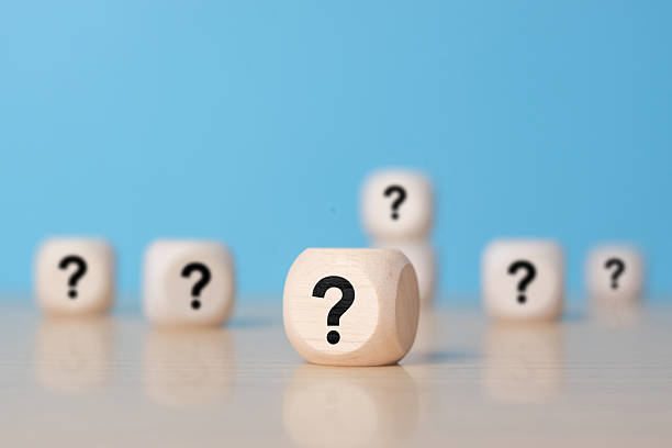 istock wooden blocks with question marks on wooden table, close up. 2253357686