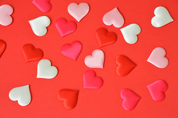 istock a valentine's background with Scattered Hearts on Red Background 2253359904
